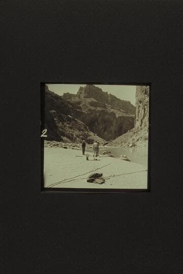 Preparing to depart from the head of President Harding Rapid.  Taylor is at left.  Eisaman walks toward Belknap.  In "Rattlesnake" are Cutler, Desloge, and Sanderson.  The other boat is the "Cactus."