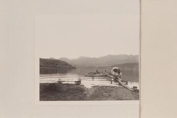 The Nevills sadirons at the Pierce Ferry dock after having been towed there by Bill Green's motorboat shown at right