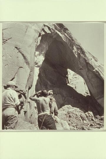 Masland registers satisfaction in the sight of the hole back of the arch. Marston and Visbak photograph the register. Masland has suggested the arch be named Arch in the Sky. It is believed to be a discovery
